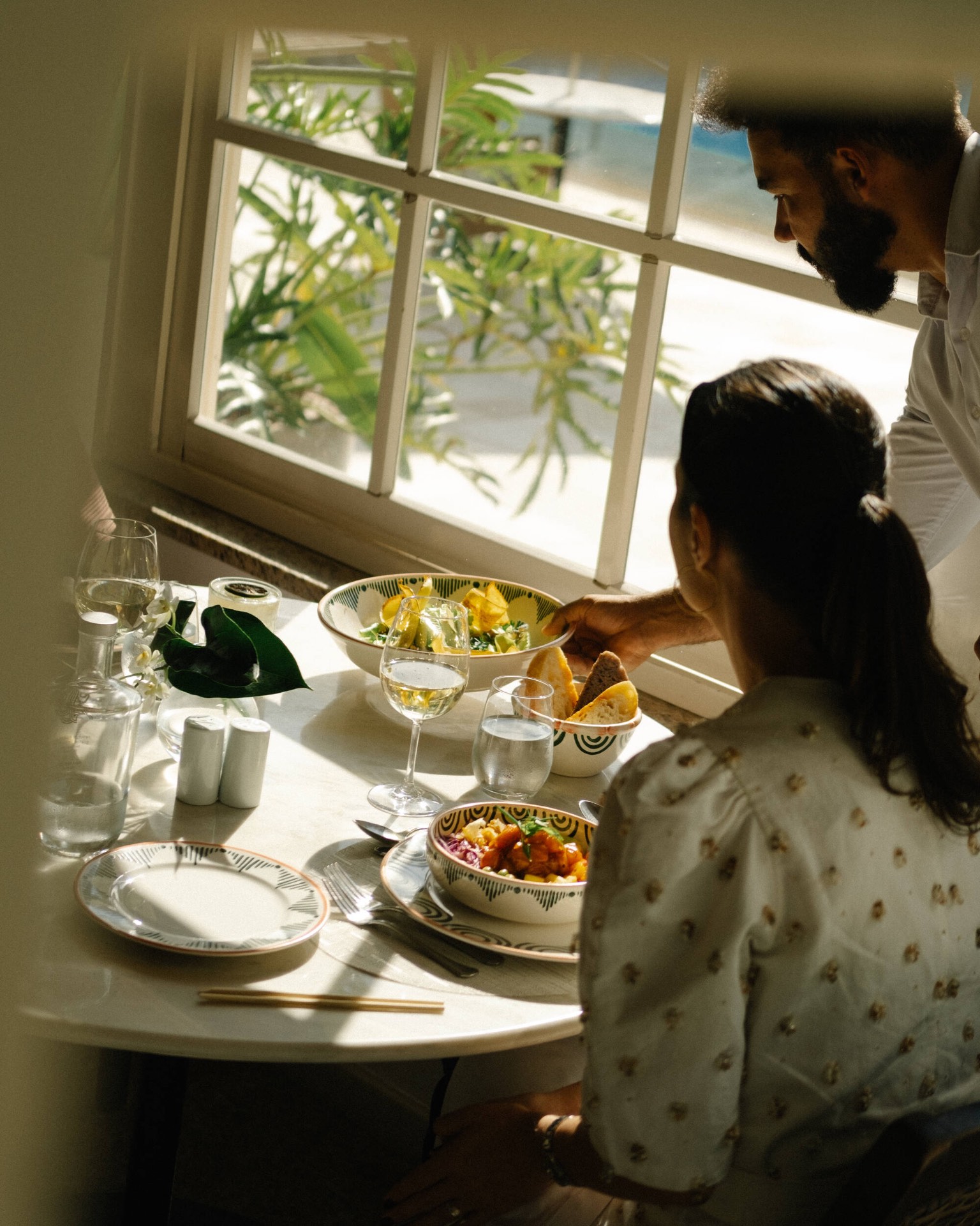 Sunlit dining by the window at Belmond